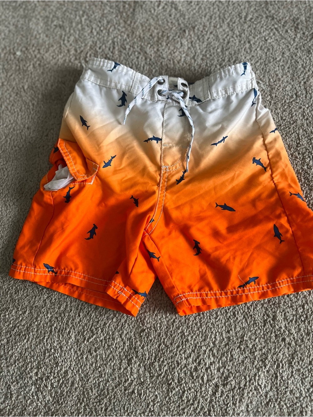 OshKosh B'gosh White to Orange Ombre Swim Trunks with Navy Shark Print